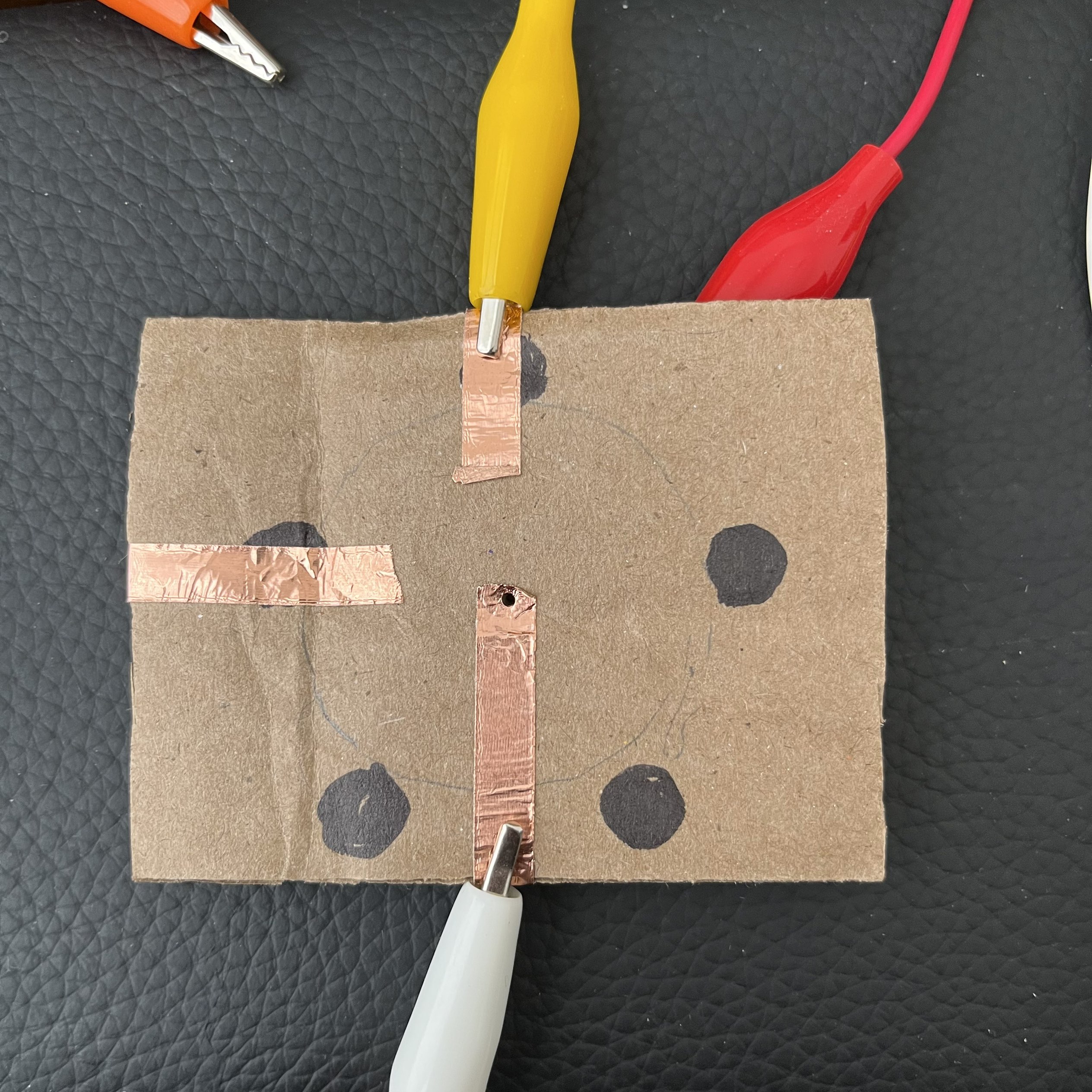 This is how it looks like under the knob. The copper tape is attached to the metal part of the pin, and the pin pierces into the copper tape that connects to the ground.