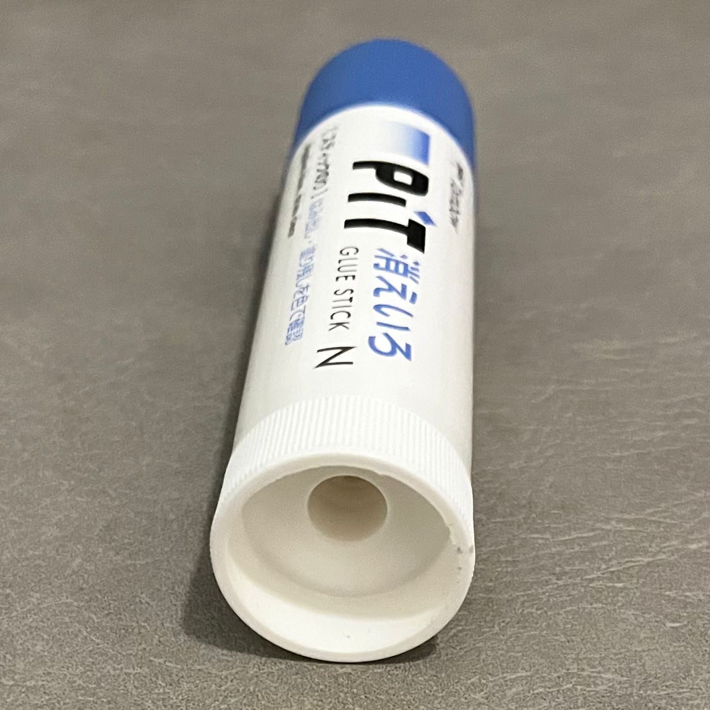 The photo of glue, while the glue is lying down. It was taken from behind, the bottom of the glue.