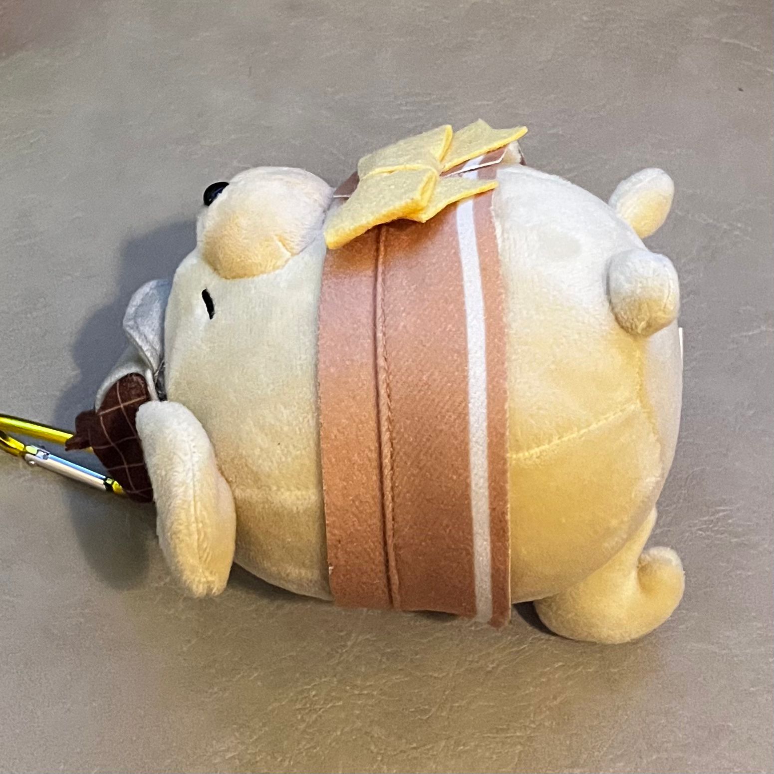 This photo is a side view of the dog plush.