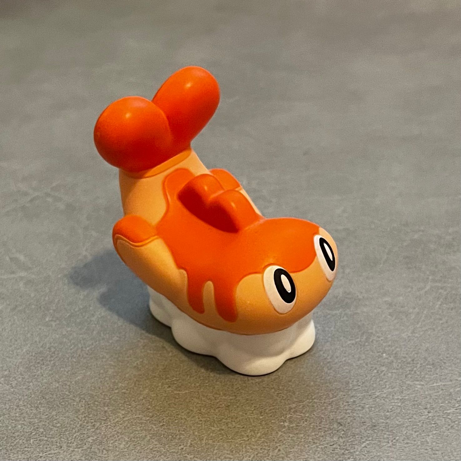 This is a photo of a pokemon figure. It was taken at a 3/4 view. There are multiple extrusions on its body, consider as complex geometry object.